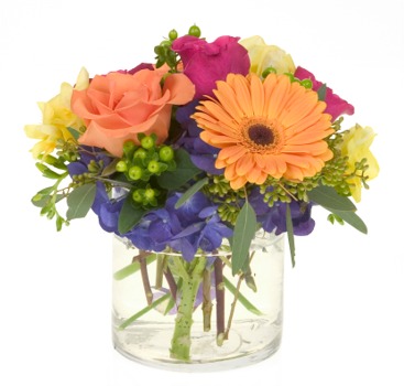 All the pretty choices a medley of colors, fragrance and flowers overflow a contemporary clear round bowl.
